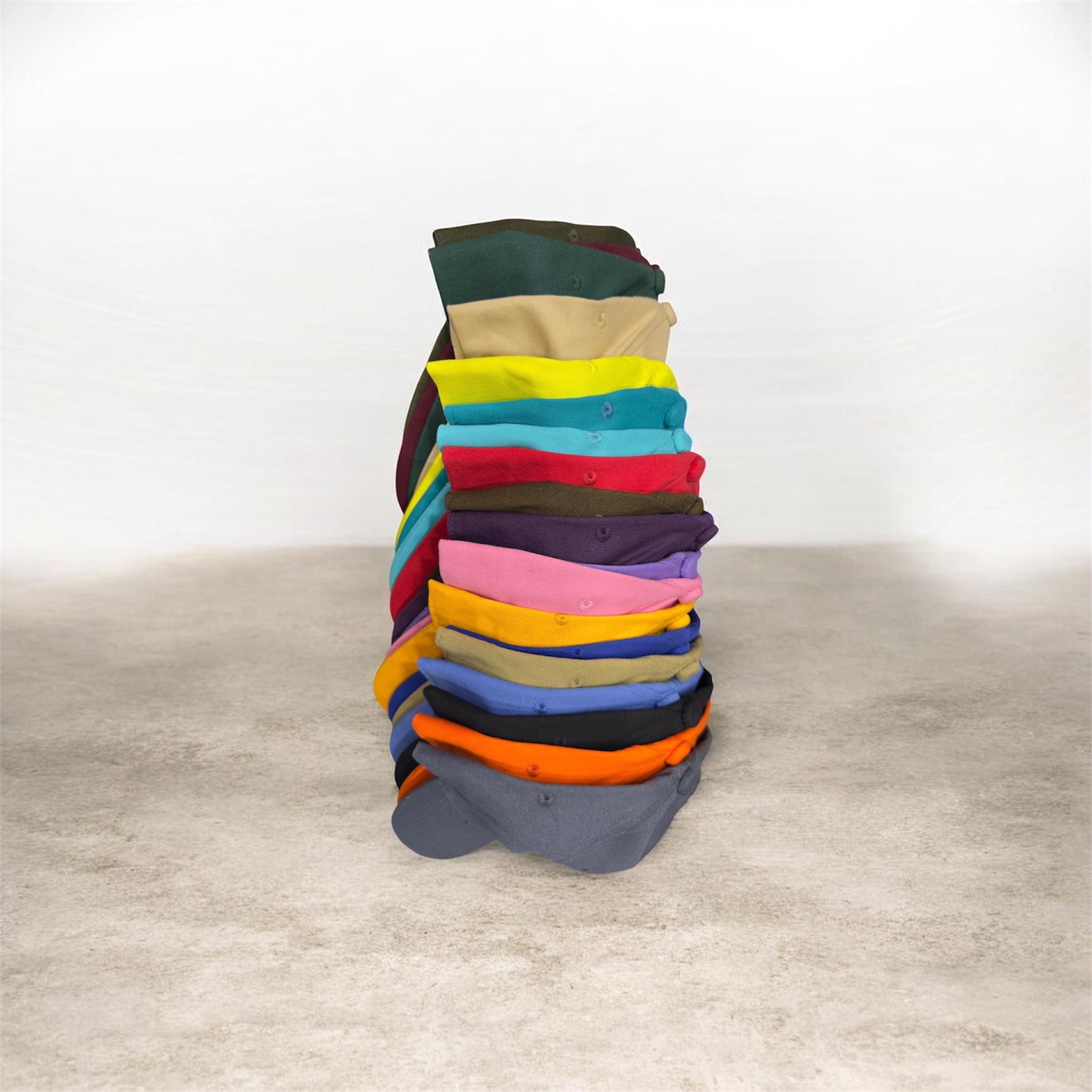 Stack of custom caps in multiple colours, ready stock at Delhi factory